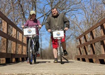 People riding bikes over bridge